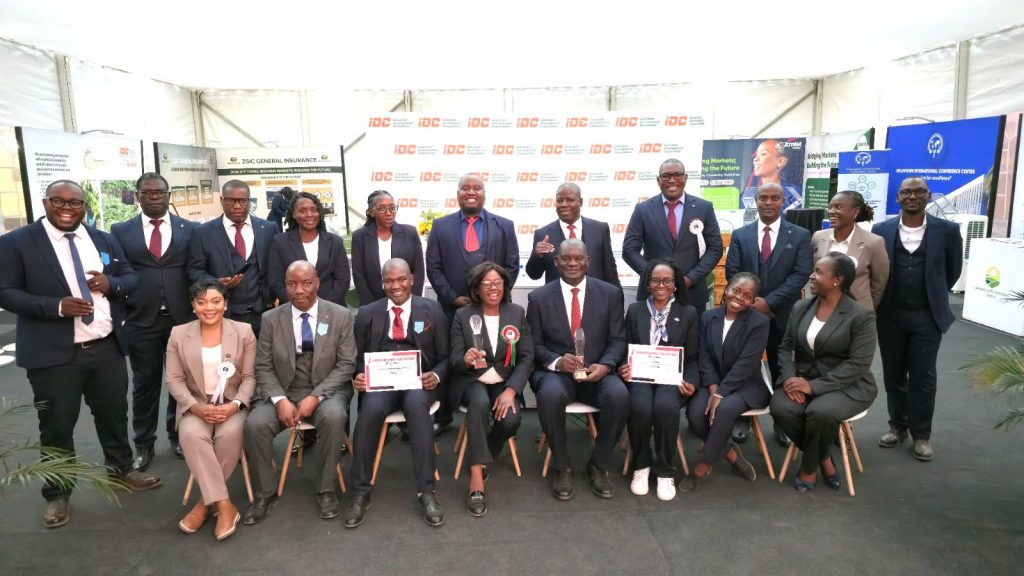 IDC team and portfolio company representatives display awards received at the 60th Zambia International Trade Fair.