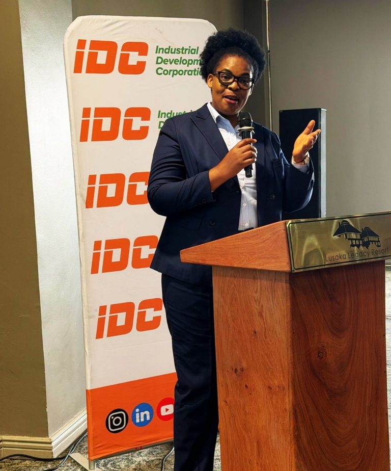 A woman speaker addresses delegates at an IDC podium during the audit and risk management conference.