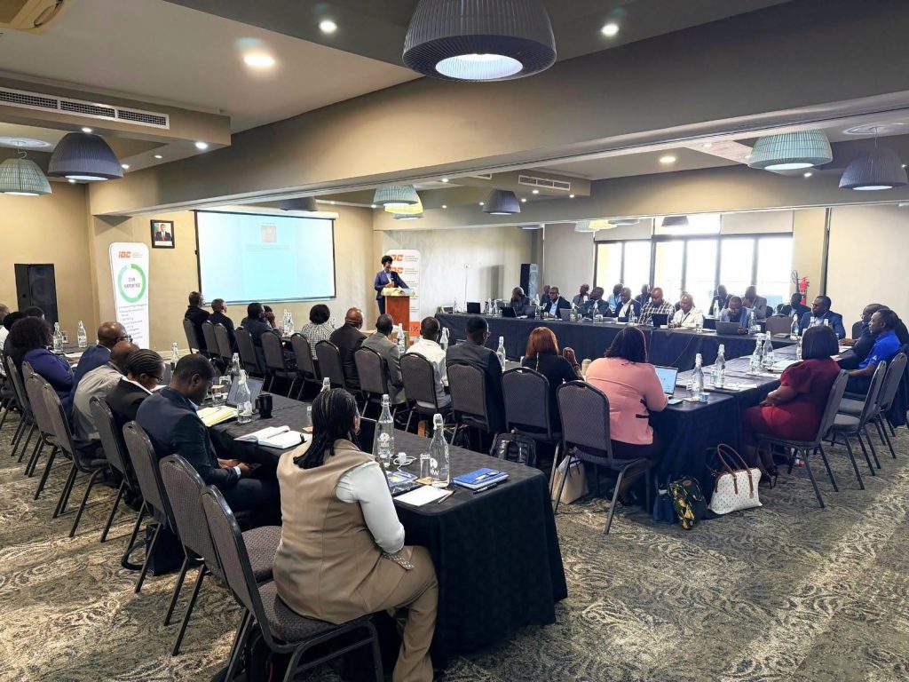 A wide view of conference delegates seated in a meeting room.