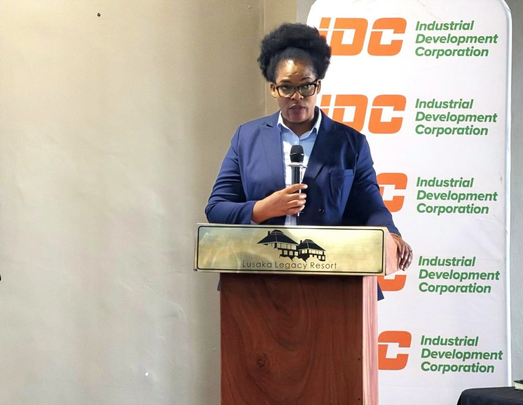 A woman speaker addresses the conference from an IDC-branded podium.