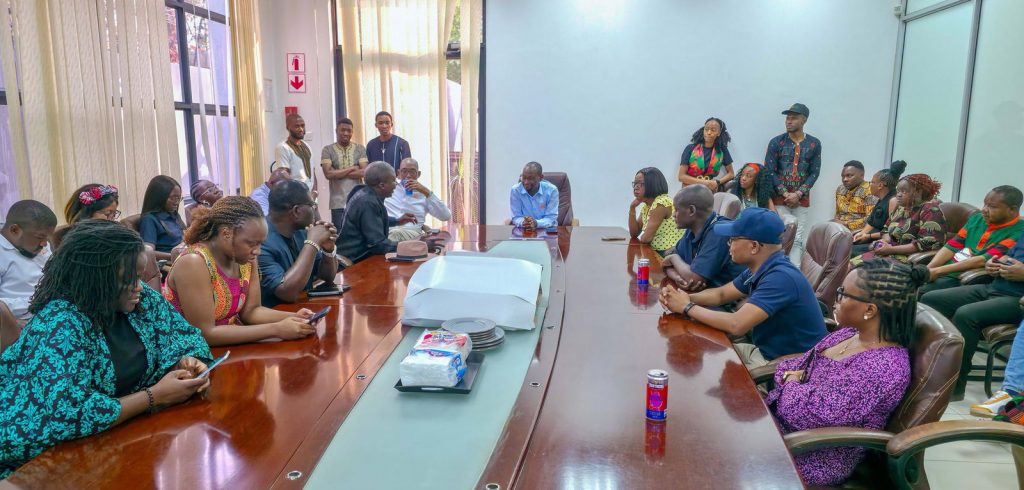 A wide view of IDC staff filling the boardroom for the Independence anniversary commemoration.