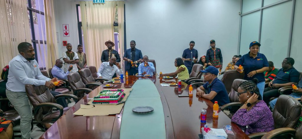 IDC staff gathered around the boardroom table during the Independence anniversary celebration.