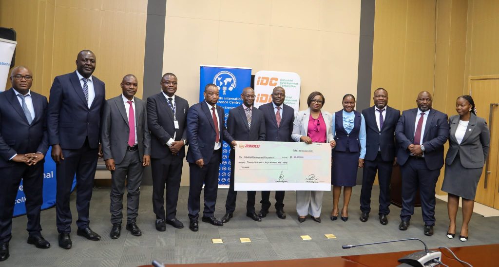 Delegates pose with the MICC dividend cheque at the handover ceremony