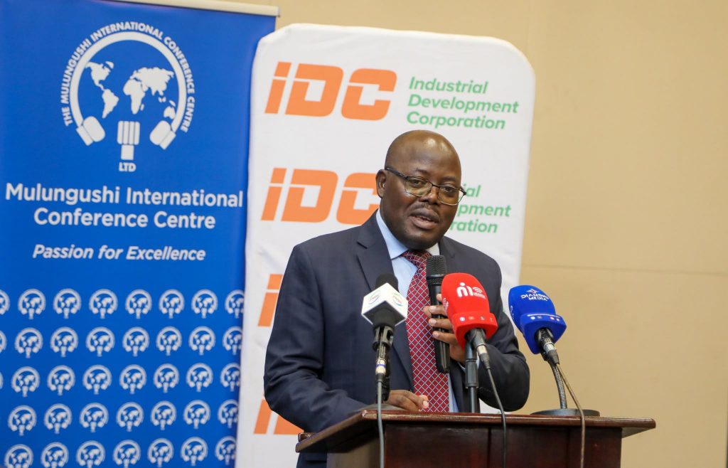 A speaker addresses the MICC dividend handover ceremony at a lectern