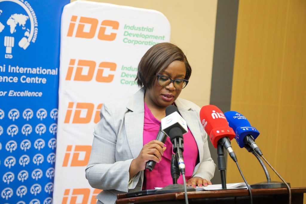 A MICC representative delivers remarks at the dividend handover ceremony
