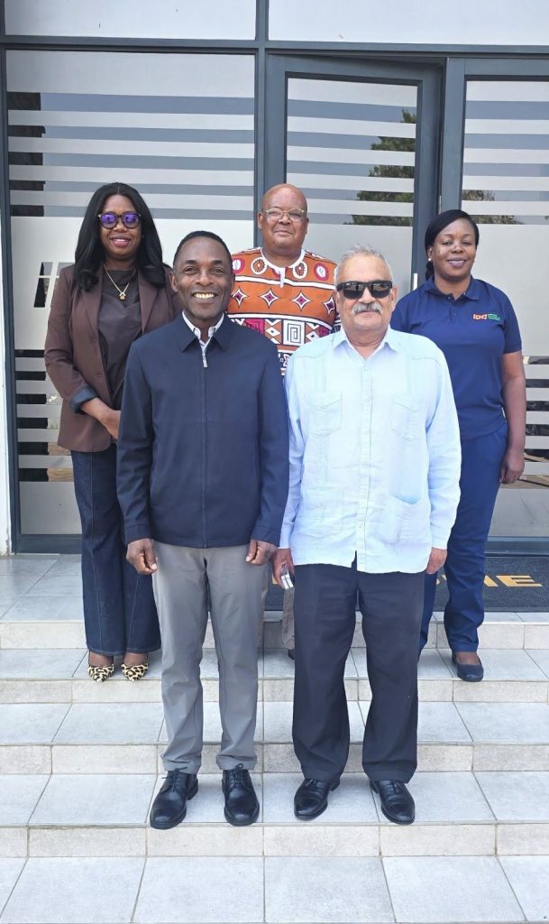 IDC and South African High Commission officials pose for a group photograph at the entrance to IDC offices.