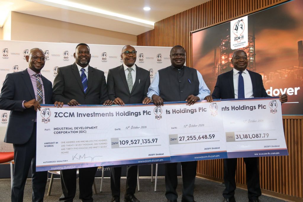 Representatives display ZCCM-IH dividend cheques for IDC, NAPSA and the Ministry of Finance